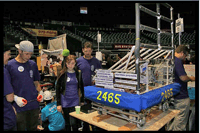High school students and mentors work on an FRC robot at the Hawaii Regional Tournament.